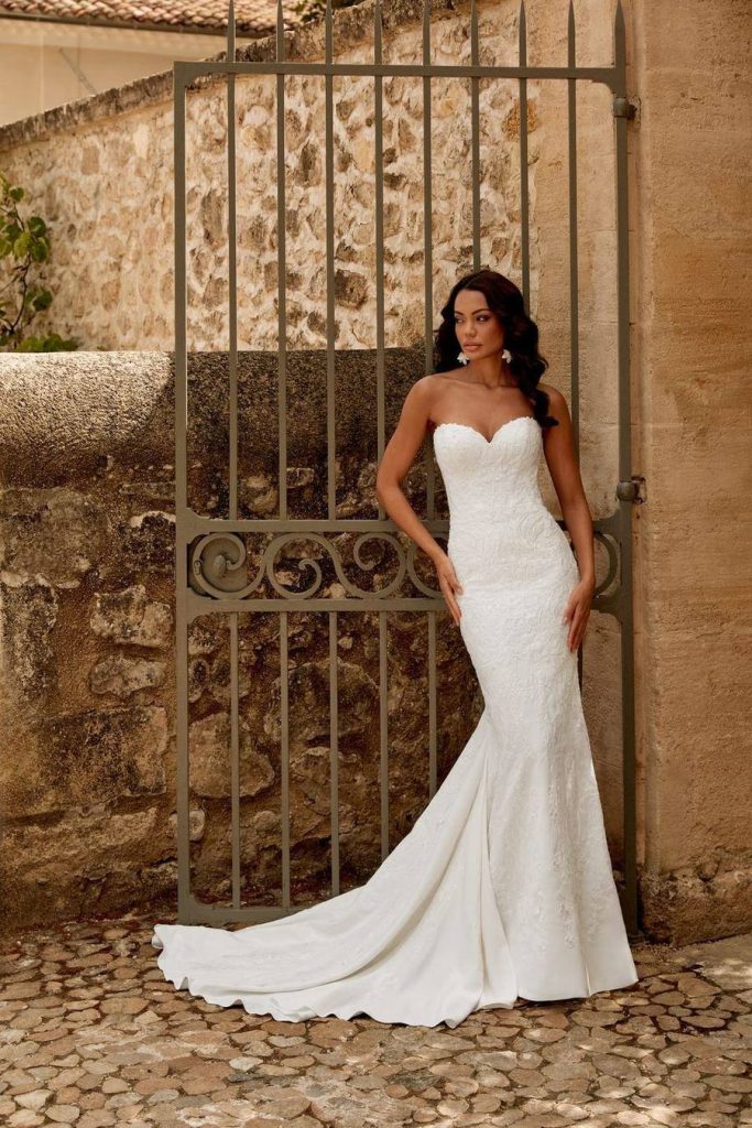 Strapless sweetheart fit and flare gown in patterned lace with a long train